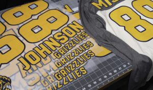 Pre-spaced heat transfer numbers and names for team uniform decorating