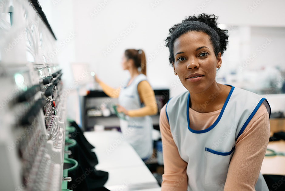 decorators operating a commercial embroidery machine